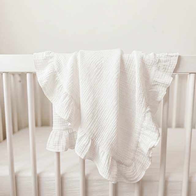 OEKO-TEX Certified White Ruffle Muslin Baby Blanket on Crib - Custom OEM Manufacturer